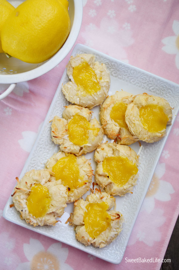 Jump into spring with these tasty Lemon Coconut Thumprint Cookies. Includes a simple homemade lemon curd recipe too! | Sweet Baked Life